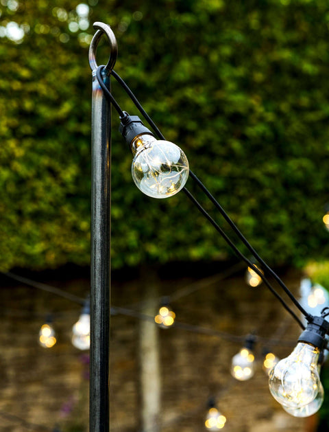 Steel festoon poles for outdoor lighting with bull horn design on garden patio