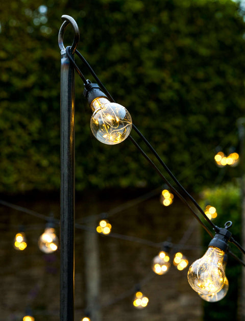 Steel festoon poles for outdoor lighting in a garden setting