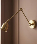 Pooky Pick Brass Wall Light with adjustable brass arm and solid brass hood, ideal for bedside reading, task lighting, and stylish interior wall illumination.