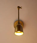 Pooky Pick Brass Wall Light with adjustable brass arm and solid brass hood, ideal for bedside reading, task lighting, and stylish interior wall illumination.