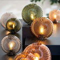 Salcombe Glass Cordless Table Lamp with seashell-inspired multi-faceted glass design emitting soft diffused glow in various colors