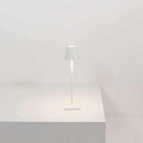 Zafferano Poldina Micro rechargeable white LED table lamp with touch brightness control on a white surface