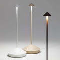 Three Zafferano Pina Pro rechargeable sand table lamps in white, beige, and black with modern cone-shaped design and adjustable brightness.