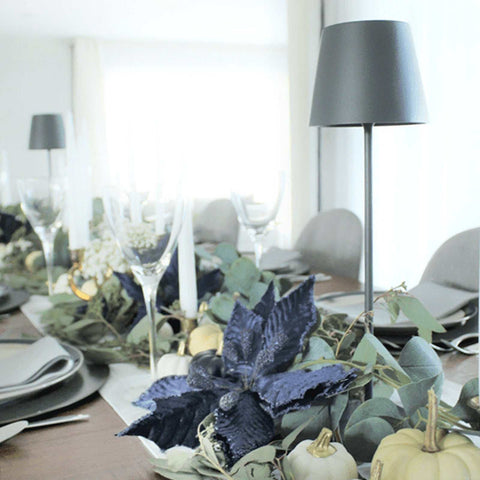 Zafferano Poldina Pro rechargeable sage table lamp on elegant dining table with floral centerpiece and glassware
