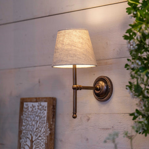 Finberry Fabric Shade Lupin wall light with beige fabric shade and bronze fitting mounted on wooden wall for ambient lighting