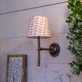 Finberry fabric shade Lupin wall light with patterned fabric shade and bronze finish on wooden wall