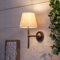 Finberry fabric shade Lupin wall light with beige fabric shade and bronze finish mounted on wooden wall providing ambient lighting