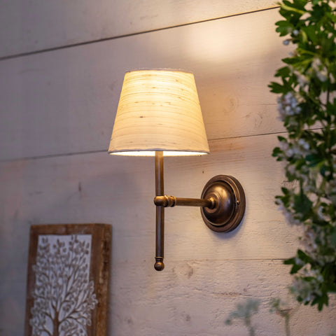 Finberry fabric shade Lupin wall light with beige fabric shade and bronze finish mounted on wooden wall providing ambient lighting