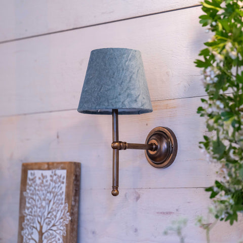 Finberry Fabric Shade Lupin wall light with blue fabric shade and bronze fitting mounted on wooden wall.