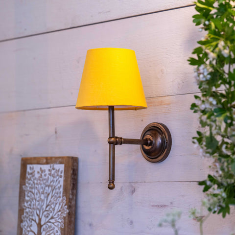 Finberry Fabric Shade Lupin wall light with yellow fabric shade and bronze finish mount on wooden wall