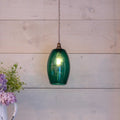 Camber small teal glass pendant light hanging with bulb on wooden wall background