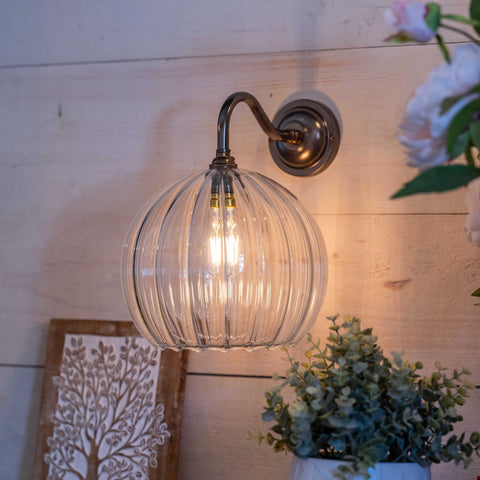 Soho Large Ribbed Glass Shade wall light with ribbed glass shade and bronze finish mounted on wooden wall near plants and decorative artwork