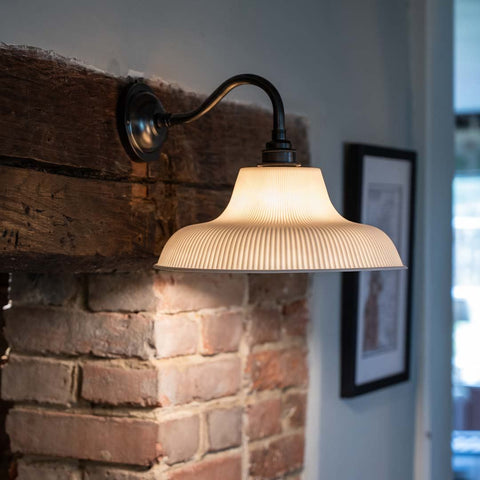 Harington Ceramic Shade Wall Light with ribbed ceramic shade and swan neck arm providing soft warm light