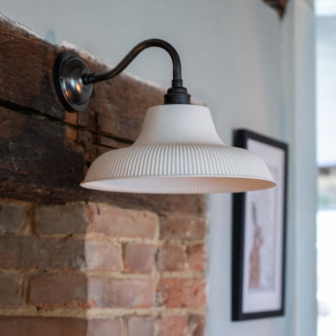 Harington Ceramic Shade Wall Light with ribbed ceramic shade and swan neck arm providing warm ambient lighting