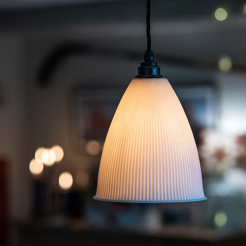 Grosvenor Ribbed Ceramic Shade Pendant Light with flared ribbed ceramic shade emitting warm ambient light