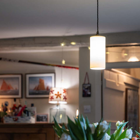 Stockwell Large Ceramic Shade Pendant Light with smooth cylindrical ceramic shade hanging over a dining table