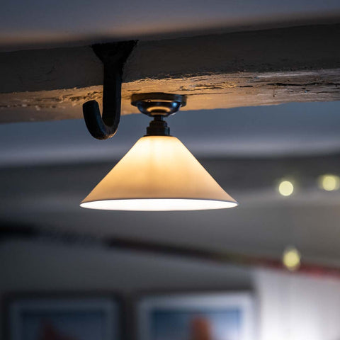 Coolie Ceramic Shade Flush Ceiling Light mounted on a wooden beam