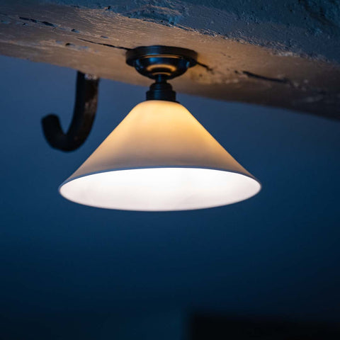 Coolie Ceramic Shade Flush Ceiling Light mounted on a wooden beam
