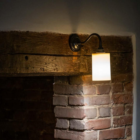 Stockwell Small Ceramic Shade Wall Light with smooth cylindrical ceramic design and warm downward light