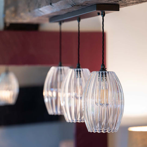 Bespoke bar pendant light with three medium ribbed camber glass shades over kitchen island