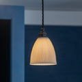 Hartlip Ceramic Shade Pendant Light with ribbed ceramic shade and dark metal fitting providing warm, diffused ambient light for kitchens and dining areas