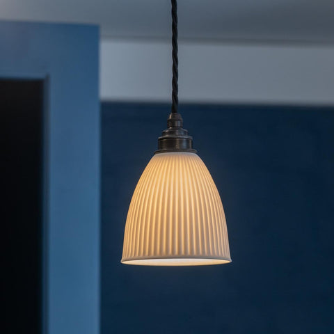 Hartlip Ceramic Shade Pendant Light with ribbed ceramic shade and dark metal fitting providing warm, diffused ambient light for kitchens and dining areas