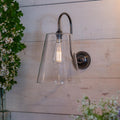 Newbury Large Clear Shade Long Swan Wall Light with clear glass shade and swan neck arm in antique brass finish
