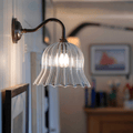 Bodium Medium Ribbed Glass Wall Light with flared shade illuminating a cozy interior space