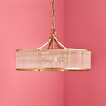 Pooky Athena Chandelier pendant light with brass detailing and crystal-clear glass rods illuminating interior space