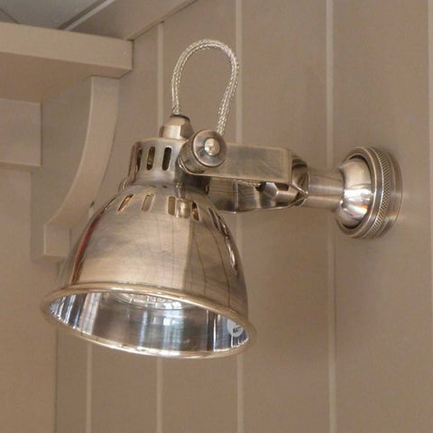 Metallic Foxton Adjustable Spotlight wall light with industrial design mounted on beige wall