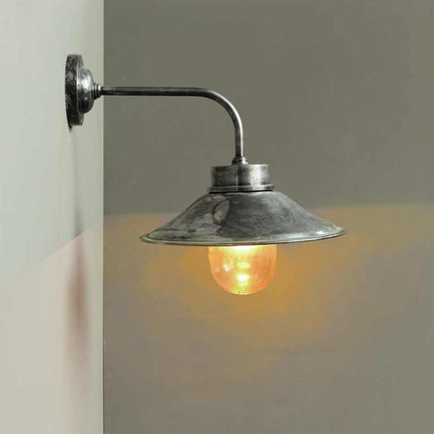Wheston Wall Light by Chehoma in antique silver metal with industrial design and warm glowing bulb