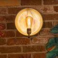 Chulainn Dish Wall Light with vintage brass dish and Edison bulb on brick wall