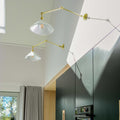 Rebell Prismatic Adjustable Wall Light with prismatic glass shade and brass finish mounted on kitchen wall