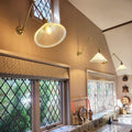 Rebell Prismatic Adjustable Wall Light with antique brass finish and prismatic glass shade in kitchen setting