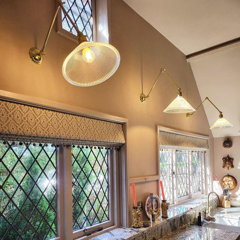 Rebell Prismatic Adjustable Wall Light with antique brass finish and prismatic glass shade in kitchen setting