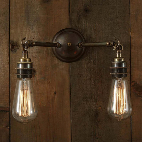 Kempton Double Wall Light with vintage filament bulbs and industrial double-arm design on wooden wall