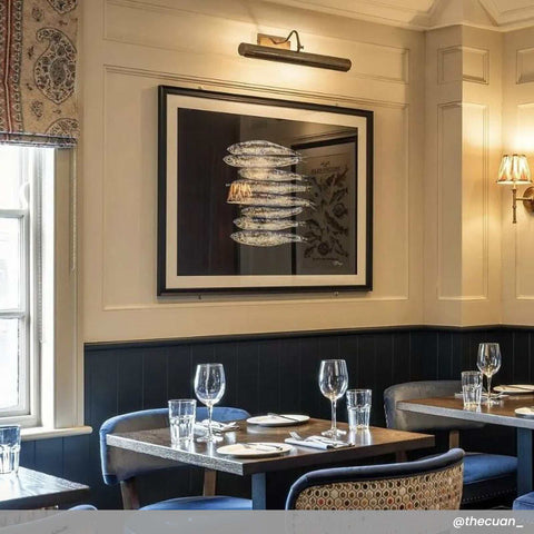 Dublin Picture Light solid brass adjustable wall light illuminating framed artwork in elegant dining room
