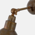 Close-up of adjustable Moorlea Brass Wall Light with vintage aged metal finish and industrial design