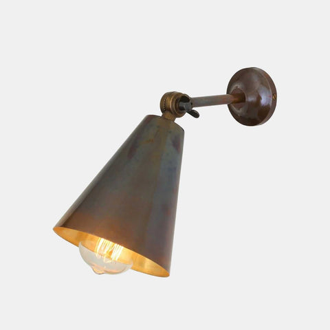 Moya Brass Wall Light with adjustable arm and cone-shaped shade in industrial brass finish