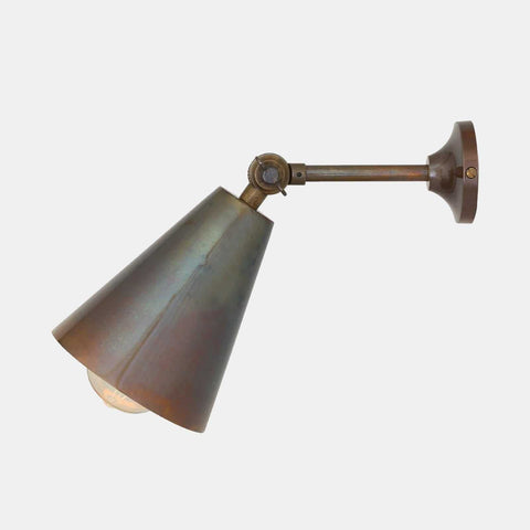 Adjustable Moya Brass Wall Light with cone-shaped shade and swivel arm, ideal for reading or task lighting.