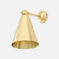 Moya Brass Wall Light with adjustable arm and cone-shaped shade in sleek brass finish, ideal for bedside or task lighting.