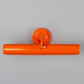 Coloured Dublin Picture Light in orange solid brass with adjustable swiveling head mounted on wall