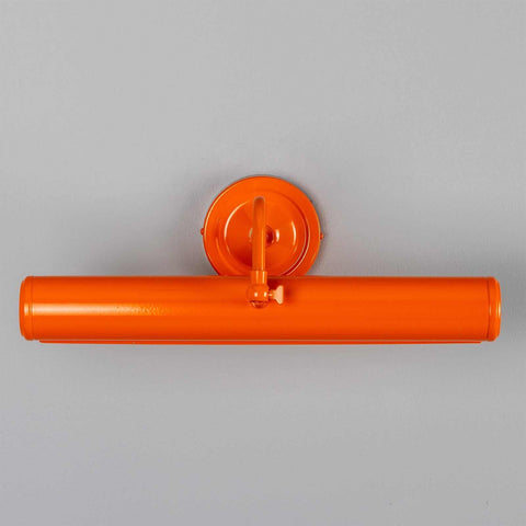 Coloured Dublin Picture Light in orange solid brass with adjustable swiveling head mounted on wall