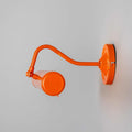 Coloured Dublin Picture Light in orange with adjustable swivel head and sleek brass design mounted on wall