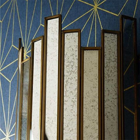 Pooky Melville Vintage Glass Wall Light with antique brass frame and vintage glass panels against blue geometric wall