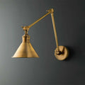 Pooky Stork Wall Light adjustable brass wall lamp in antique finish mounted on dark gray wall