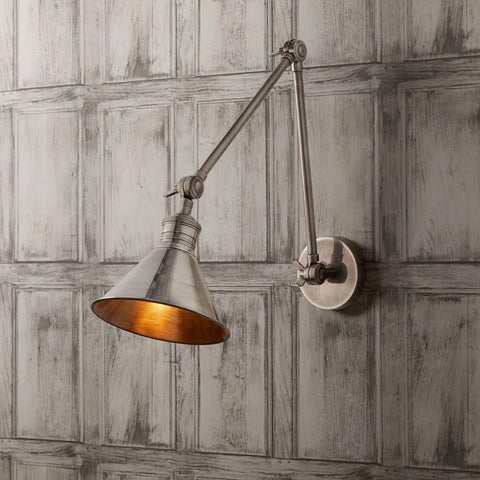 Pooky Stork Wall Light adjustable brass wall lamp in antique silver finish mounted on textured gray panel wall