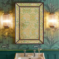 Pooky Roddy Wall Light with clear glass rods in brass finish flanking a floral patterned mirror in a vintage bathroom setting