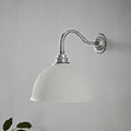 Denton Ribbed Ceramic medium wall light with handmade ribbed ceramic shade and brushed metal arm mounted on grey wall