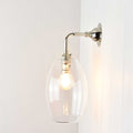 Camber Small Clear Glass Shade wall light with elongated clear glass shade and polished metal mount